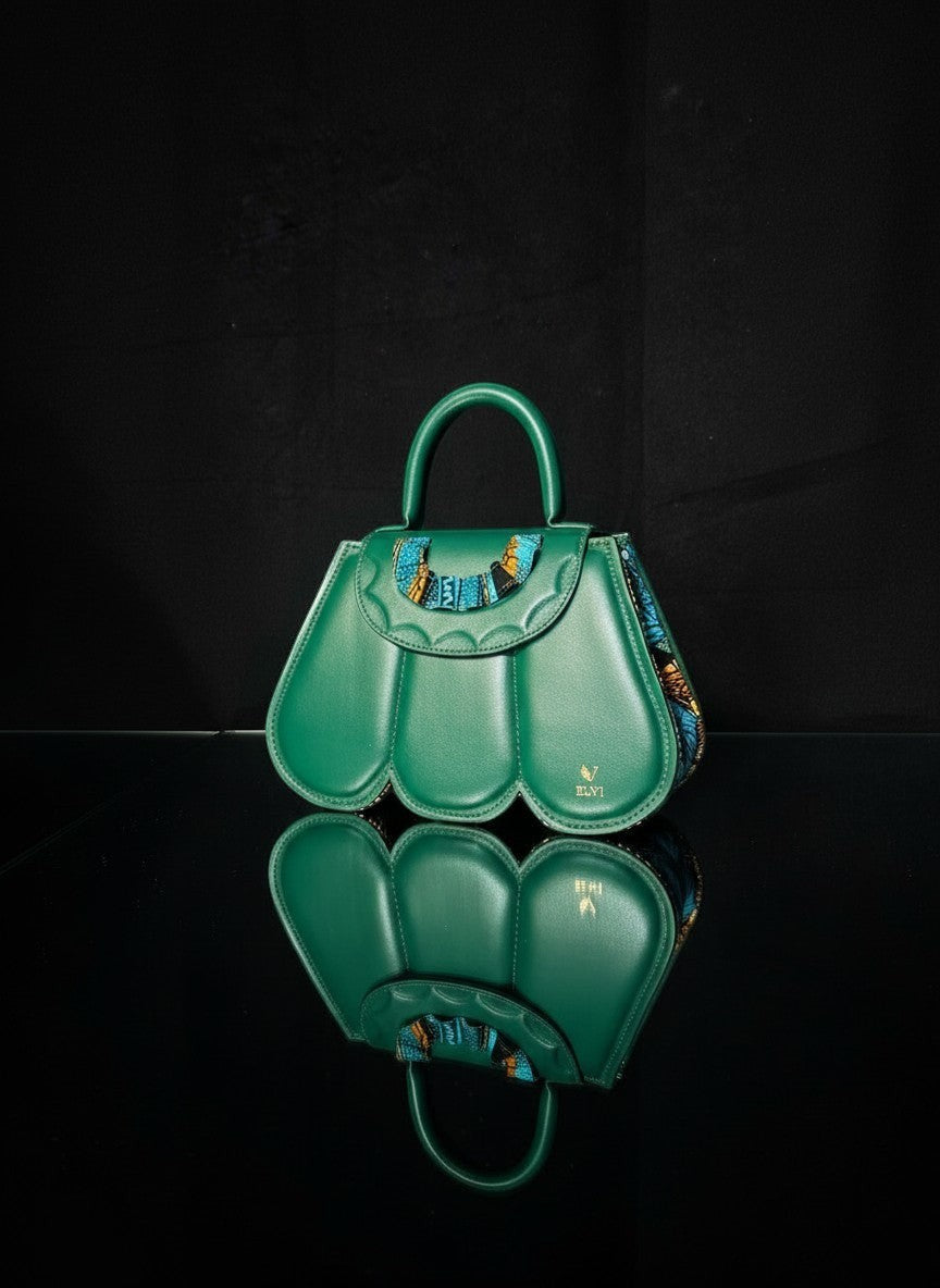 ELVI CREATION green vegan leather handbag with scalloped petal design and colourful patterned trim. Features gold hardware and a top handle.