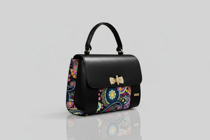 ELVI CREATION black vegan leather handbag with colorful paisley wax fabric sides and gold hardware.