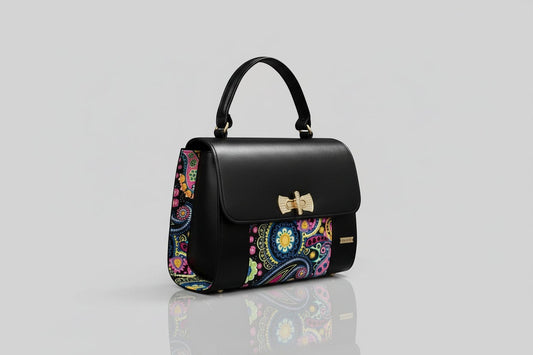 ELVI CREATION black vegan leather handbag with colorful paisley wax fabric sides and gold hardware.