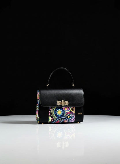 ELVI CREATION black vegan leather handbag with colorful paisley wax panels and gold hardware.