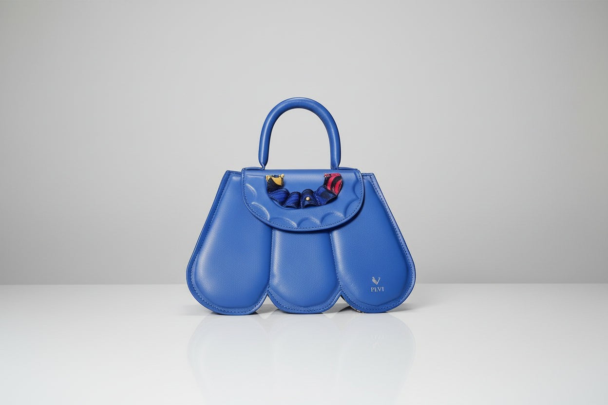 ELVI CREATION blue vegan leather Cupidon handbag with sculpted petal design and colourful fabric detail on flap.