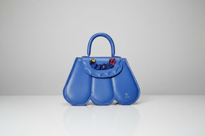 ELVI CREATION blue vegan leather Cupidon handbag with sculpted petal design and colourful fabric detail on flap.