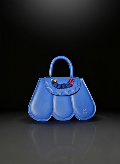 ELVI CREATION blue vegan leather Cupidon handbag with sculpted petal design and colourful fabric detail.