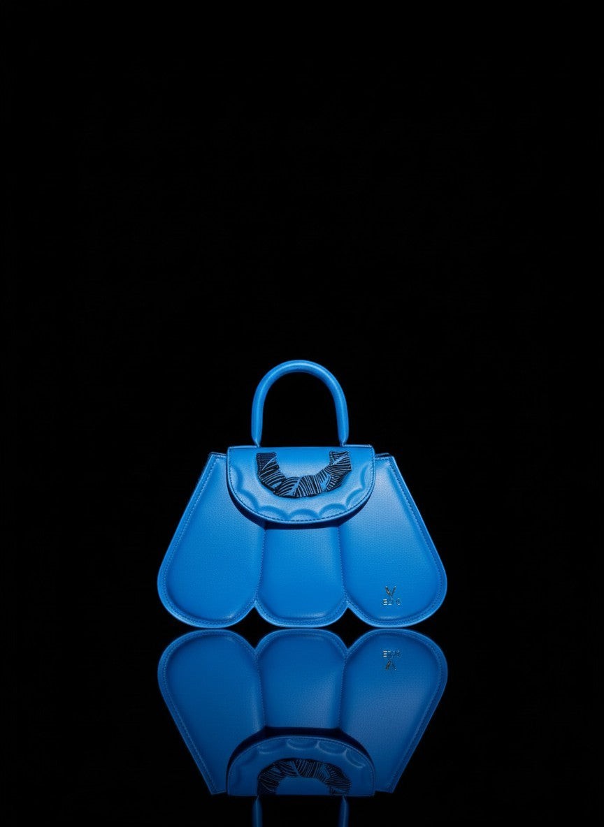 ELVI CREATION Cupidon blue vegan leather handbag with sculpted petal design and gold hardware. Includes strap.