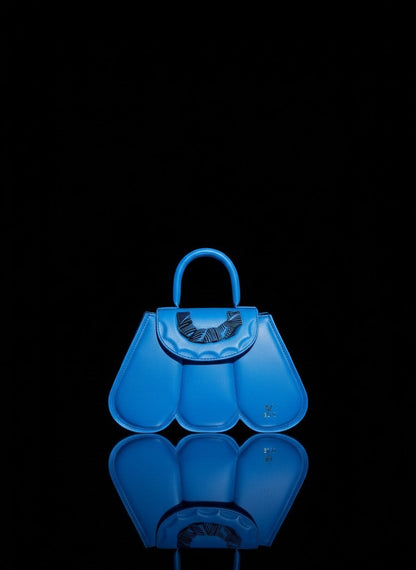 ELVI CREATION Cupidon blue vegan leather handbag with sculpted petal design and gold hardware. Includes strap.