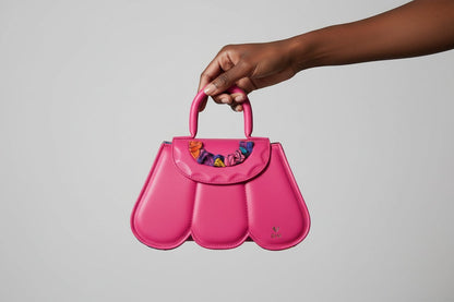 ELVI CREATION Cupidon pink vegan leather handbag with sculptural petals and colourful fabric detail.
