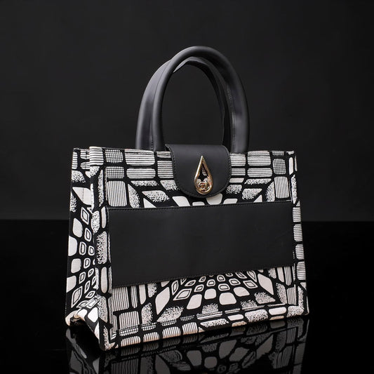 ELVI CREATION KODJO tote bag with black and white geometric African print, black vegan leather accents, and gold hardware.