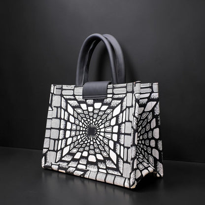 ELVI CREATION KODJO tote bag in black and white geometric African print, vegan leather handles, gold hardware.
