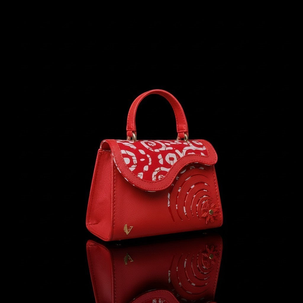 ELVI CREATION Elsha mini red vegan leather handbag with floral appliques, spiral cutouts, and wax print lining.