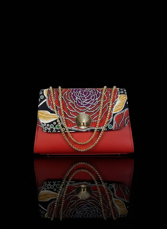 ELVI CREATION red vegan leather handbag with a large red, purple, and gold rose wax print flap and gold chain strap.