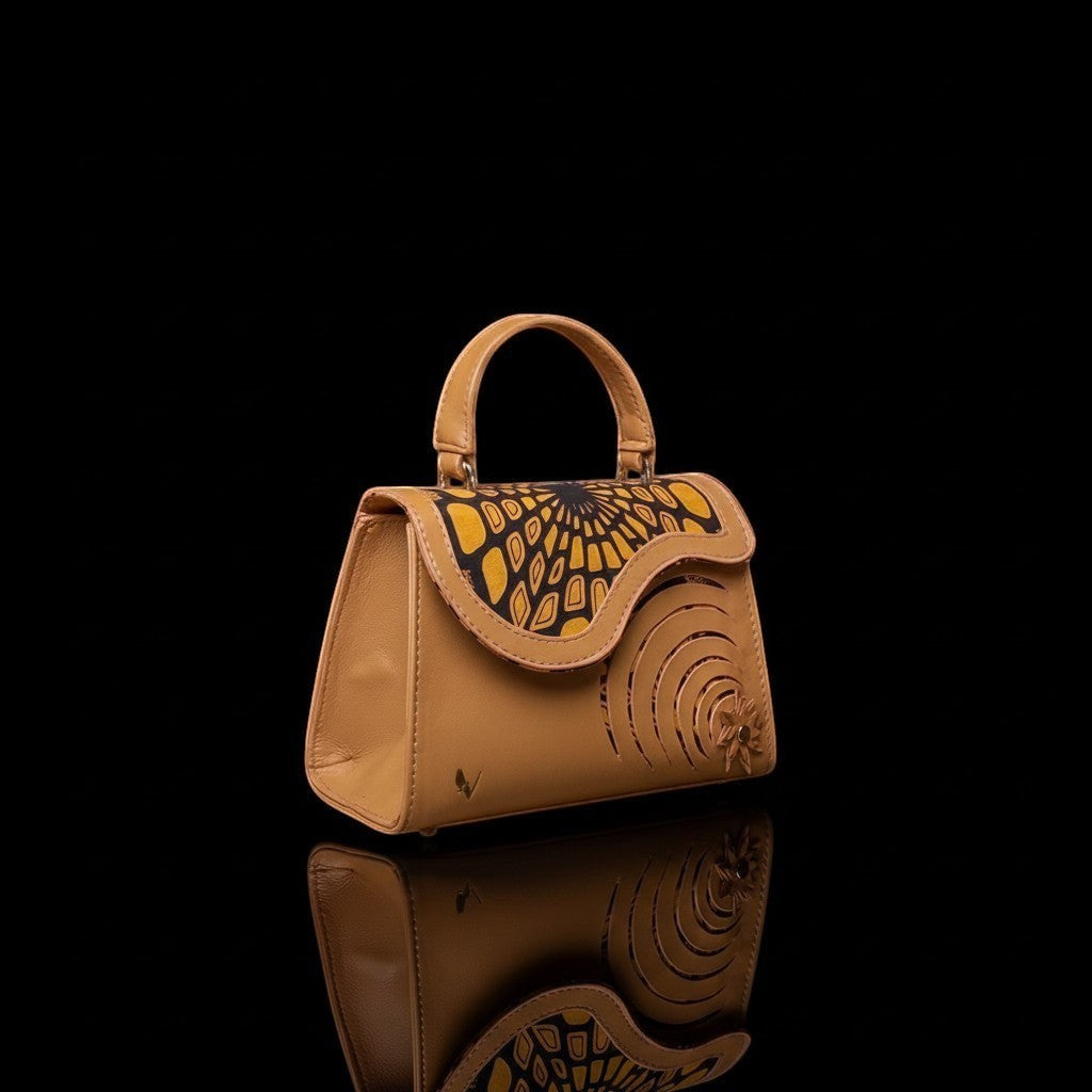 ELVI CREATION Elsha mini tan vegan leather handbag with yellow and black floral applique and spiral cutouts.