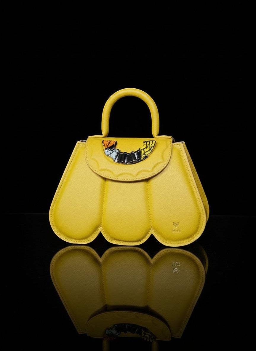 ELVI CREATION yellow vegan leather Cupidon handbag with sculpted petal design and gold hardware. Includes detachable strap.