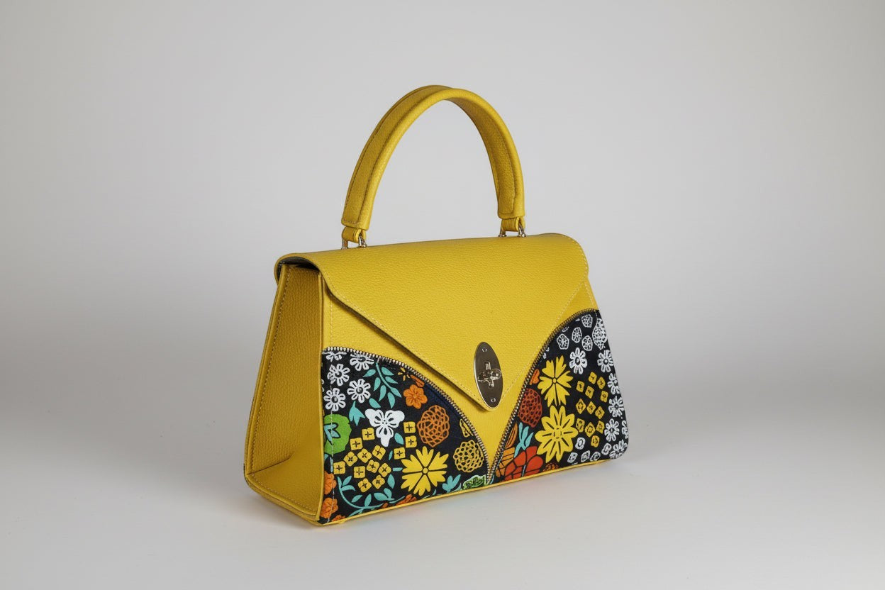 ELVI CREATION yellow vegan leather handbag with bold floral wax print panels and a silver oval clasp.