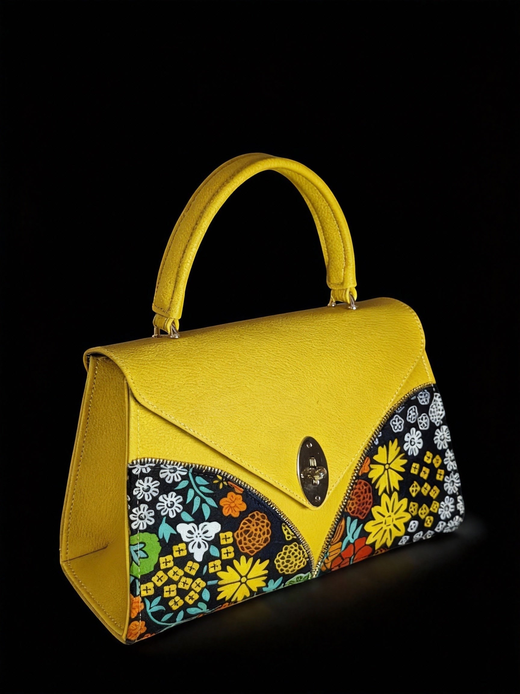 ELVI CREATION Le Saphir yellow vegan leather handbag with bold floral wax print panels and silver oval clasp.