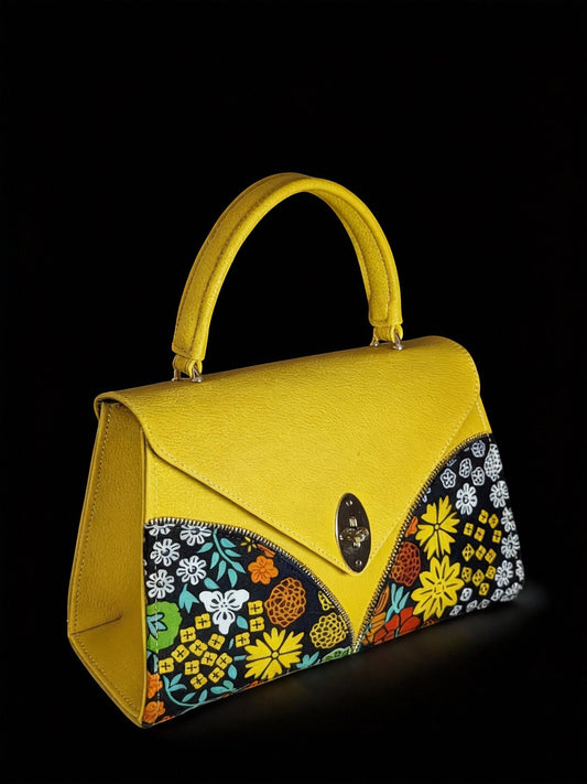 ELVI CREATION Le Saphir yellow vegan leather handbag with bold floral wax print panels and silver oval clasp.